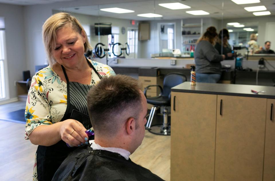 Rebecca Slater cuts the hair of Alan Paulk inside of her barber and beauty shop called "Rebecca's Barber N Beauty" on North Memorial Drive on July 31, 2023 in Lancaster, Ohio.