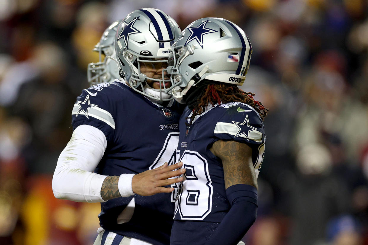 LANDOVER, MARYLAND - JANUARY 08: Quarterback Dak Prescott #4 celebrates with wide receiver CeeDee Lamb #88 of the Dallas Cowboys after connecting for a touchdown pass against the Washington Commanders at FedExField on January 08, 2023 in Landover, Maryland. (Photo by Rob Carr/Getty Images)
