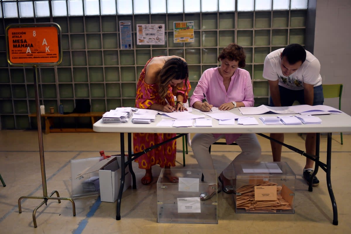 Election officials count ballots at a polling station in Pamplona, northern Spain (AP)