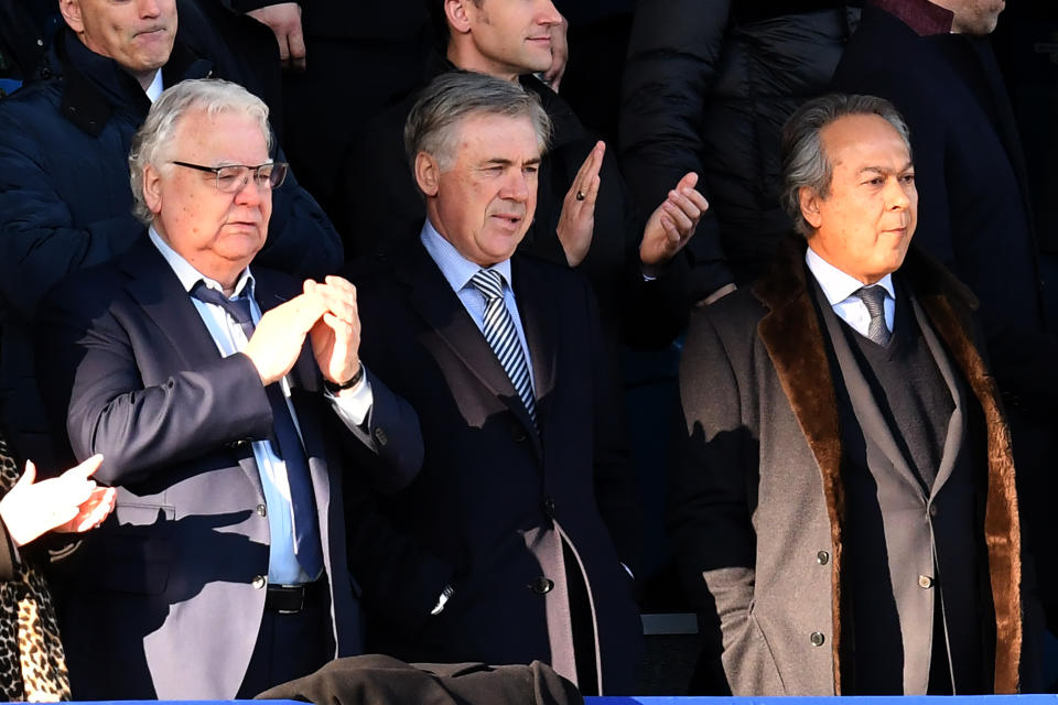 Everton's Italian head coach Carlo Ancelotti (C), Everton's English chairman Bill Kenwright (L) and Everton's Iranian owner Farhad Moshiri look on at the English Premier League football match between Everton and Arsenal at Goodison Park in Liverpool, north west England on December 21, 2019. (Photo by Paul ELLIS / AFP) / RESTRICTED TO EDITORIAL USE. No use with unauthorized audio, video, data, fixture lists, club/league logos or 'live' services. Online in-match use limited to 120 images. An additional 40 images may be used in extra time. No video emulation. Social media in-match use limited to 120 images. An additional 40 images may be used in extra time. No use in betting publications, games or single club/league/player publications. /  (Photo by PAUL ELLIS/AFP via Getty Images)