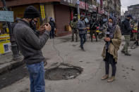 Kashmiri Journalists work during surprise search of pedestrians by security forces in Srinagar, Indian controlled Kashmir, Friday, Jan. 21, 2022. Local Kashmiri reporters were often the only eyes on the ground for the global audiences, particularly after New Delhi barred foreign journalists from the region without official approval a few years ago. Most of the coverage has focused on the Kashmir conflict and government crackdowns. Authorities are now seeking to control any narrative seen opposite to the broad consensus in India that the region is an integral part of the country. (AP Photo/Dar Yasin)