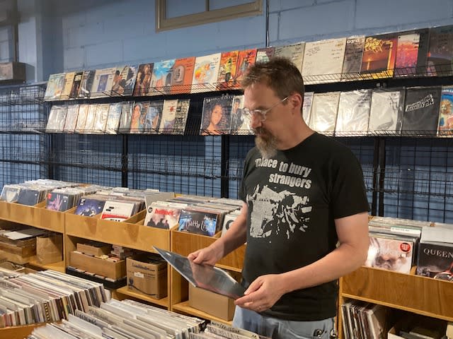 Bob Herington looks through the vinyl collection at Ragged Records, 311 E. 2nd St., Davenport (photo by Jonathan Turner).