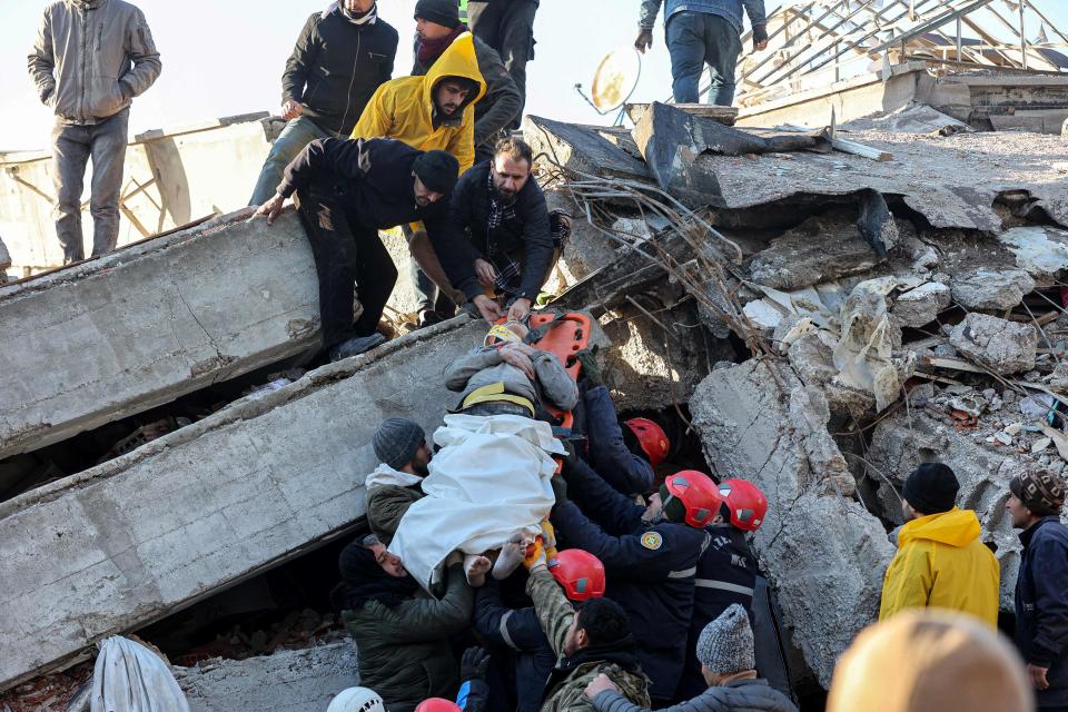 Rescue workers pull out a survivor from the rubble of a destroyed building in Kahramanmaras, southern Turkey, on Feb. 8, 2023, a day after a 7.8 magnitude earthquake struck the country's southeast.