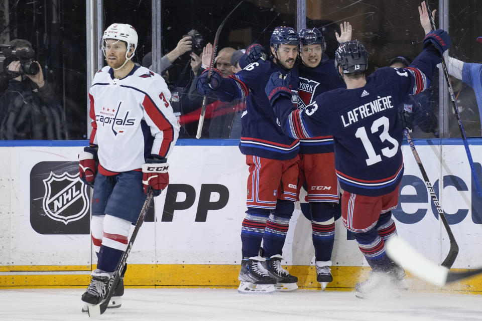 New York Rangers' Artemi Panarin, second from right, celebrates his goal with teammates during the first period of an NHL hockey game against the Washington Capitals, Sunday, Jan. 14, 2024, in New York. (AP Photo/Seth Wenig)