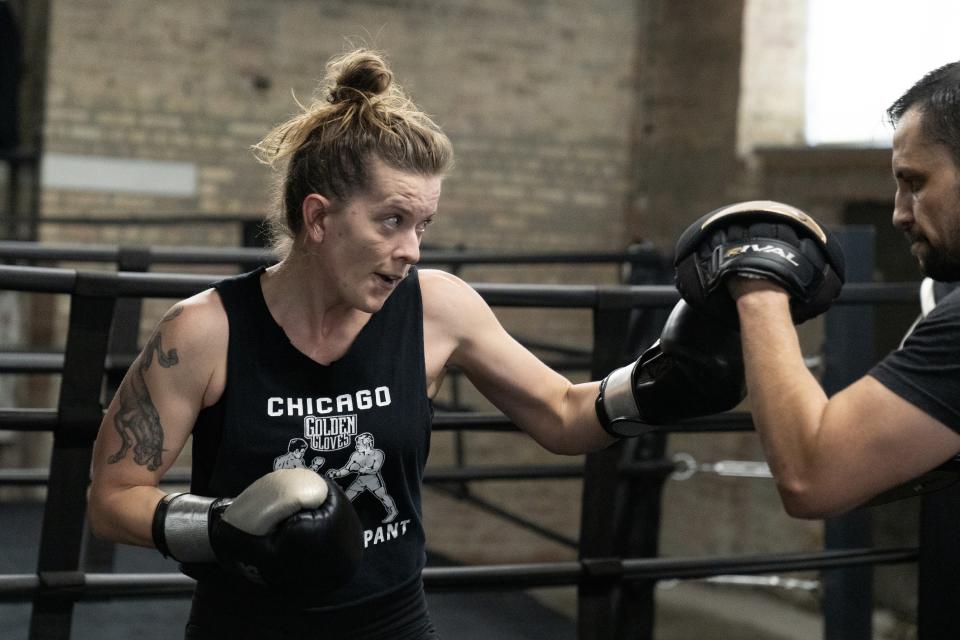 Jessie LaFree, 34, trains for the Chicago Golden Gloves boxing tournament with coach Miguel Martinez at Unanimous Boxing Gym Friday, March 17, 2023, in Chicago. LaFree is among the 40 women entered in this year's Chicago Golden Gloves tournament. The storied event that celebrated its 100th anniversary this month counts Joe Louis, Sonny Liston and Muhammad Ali when he was known as Cassius Clay as past champions. (AP Photo Erin Hooley)