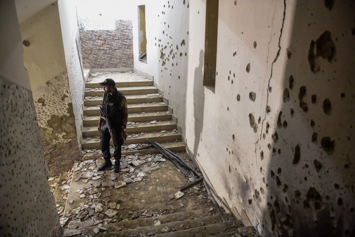 The bullet-marked police station in Karachi after the attack (AFP via Getty)