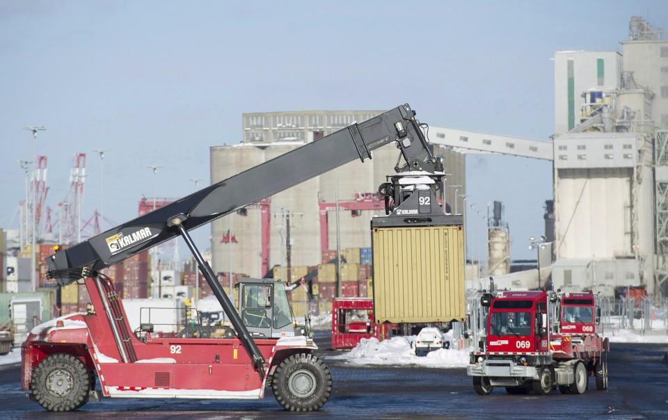 Trucks unload containers from cargo ships in the Port of Montreal in a January 4, 2016, file photo. (CP)