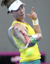 Samantha Stosur of Australia plays a shot during her match against Andrea Petkovic of Germany during the Fed Cup semifinals between Australia and Germany in Brisbane, Australia, Saturday, April 19, 2014. (AP Photo/Tertius Pickard)