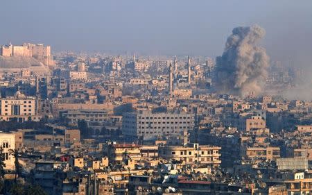 Smoke rises as seen from a rebel-held area of Aleppo, Syria December 12, 2016. REUTERS/Abdalrhman Ismail