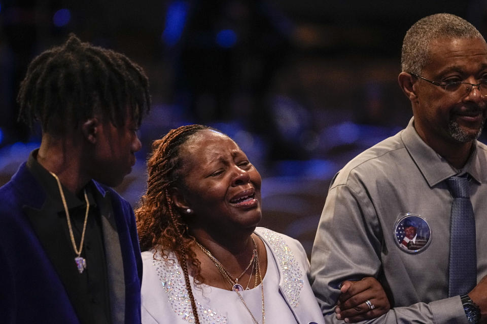 Chantemekki Fortson, left, the mother of slain airman Roger Fortson stands at his casket with family during his funeral at New Birth Missionary Baptist Church, Friday, May 17, 2024, near Atlanta. (AP Photo/Brynn Anderson)
