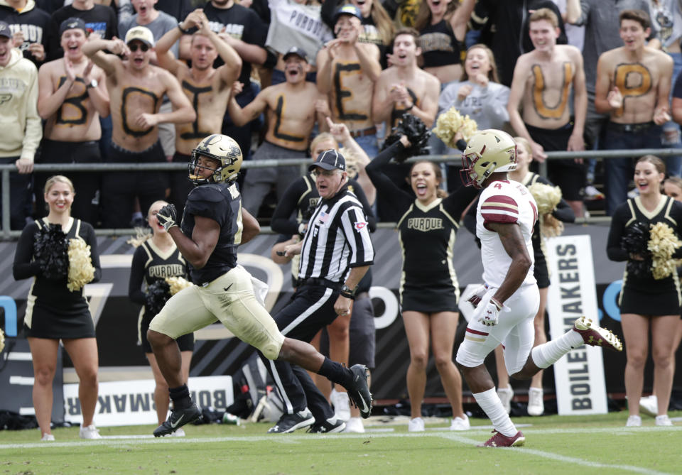 Purdue wide receiver Rondale Moore (4) runs in for a touchdown in front of Boston College defensive back Hamp Cheevers (4) during the first half of an NCAA college football game in West Lafayette, Ind., Saturday, Sept. 22, 2018. (AP Photo/Michael Conroy)