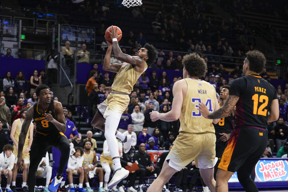 Washington forward Keion Brooks Jr. goes up for a basket against Arizona State center Shawn Phillips Jr. (9) as guard Jose Perez (12) and Washington center Braxton Meah (34) look on during the second half of an NCAA college basketball game Thursday, Jan. 11, 2024, in Seattle. Washington won 82-67. (AP Photo/Lindsey Wasson)