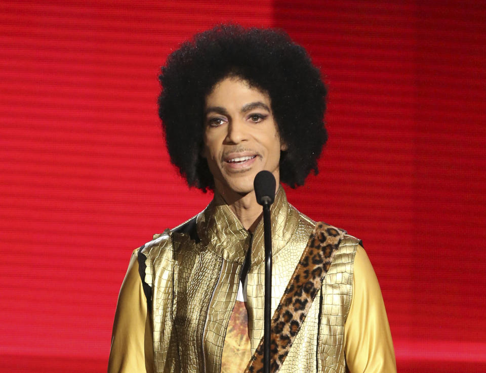 FILE - In this Nov. 22, 2015 file photo, Prince presents the award for favorite album - soul/R&B at the American Music Awards in Los Angeles. The music icon died of an accidental opioid overdose at his Paisley Park studio on April 21, 2016. He was 57. (Photo by Matt Sayles/Invision/AP, File)