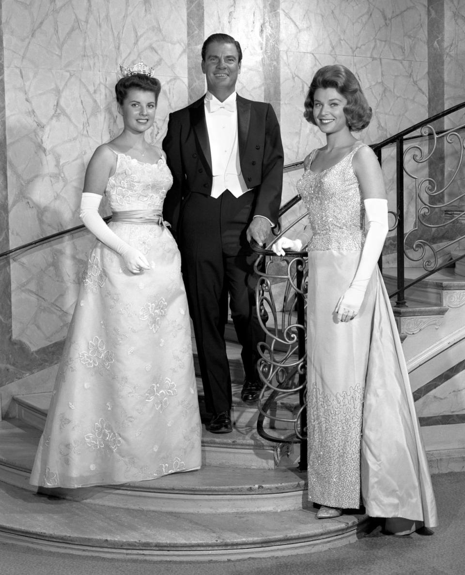 <p>Jacquelyn Mayer of Ohio, left, is the definition of pageant royalty in her floral embroidered gown. Everything about the outfit—from her satin sash to her elegant white gloves—looks straight out of a Disney movie. </p>