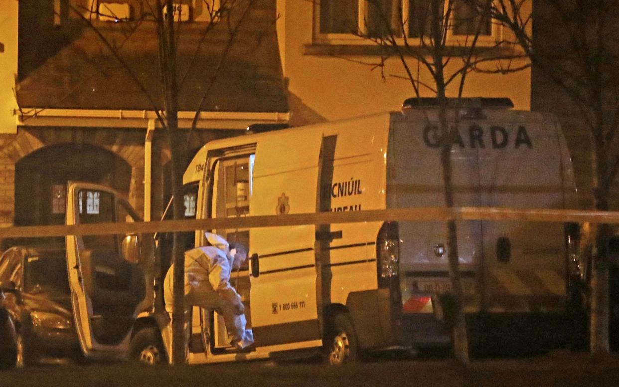 Garda forensic officers examining the semi-detached house - PA