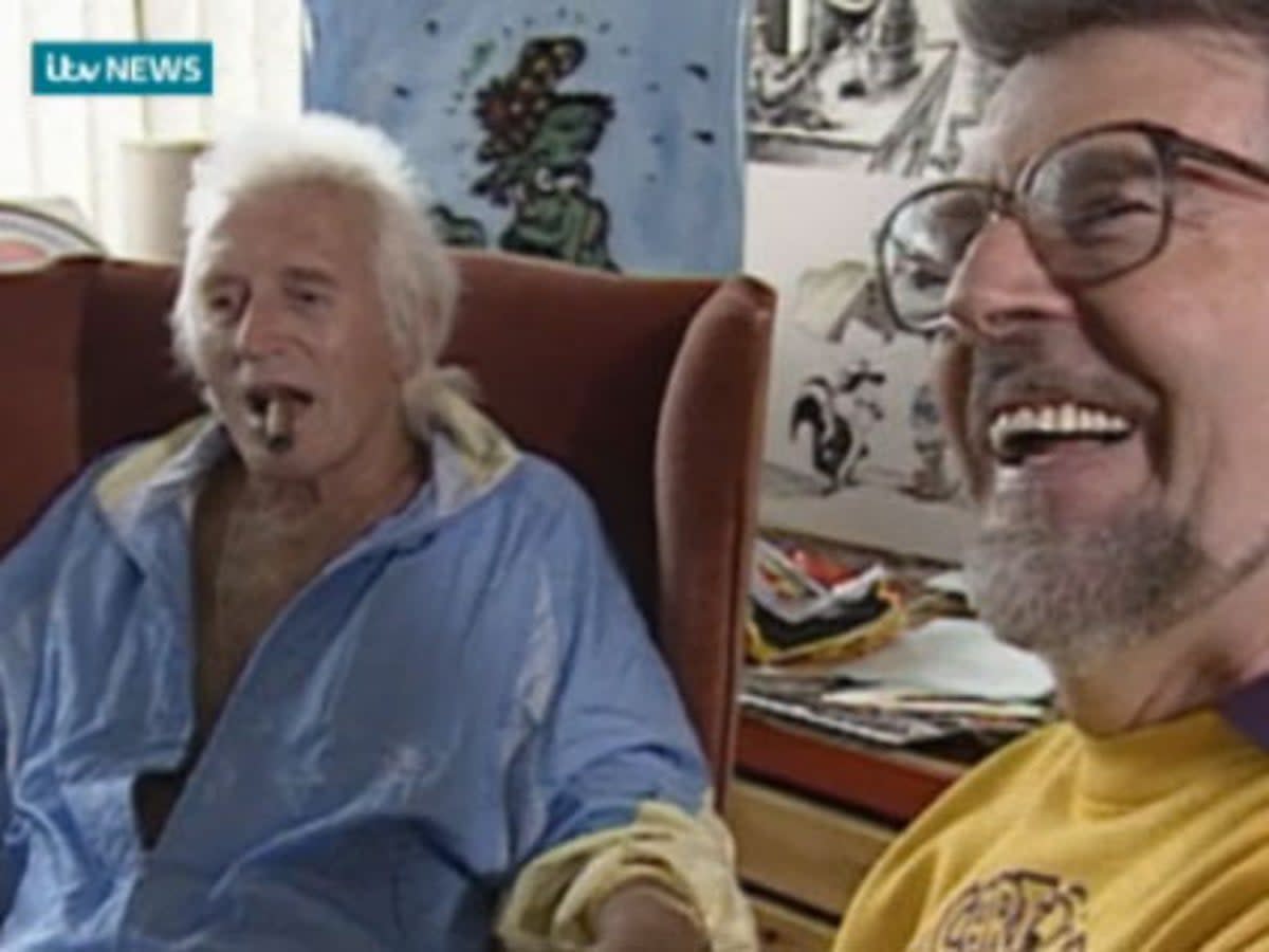 Footage from 1992 shows Rolf Harris drawing a portrait of Jimmy Savile as the pair joke together at ITV West studios in Bristol. (ITV)