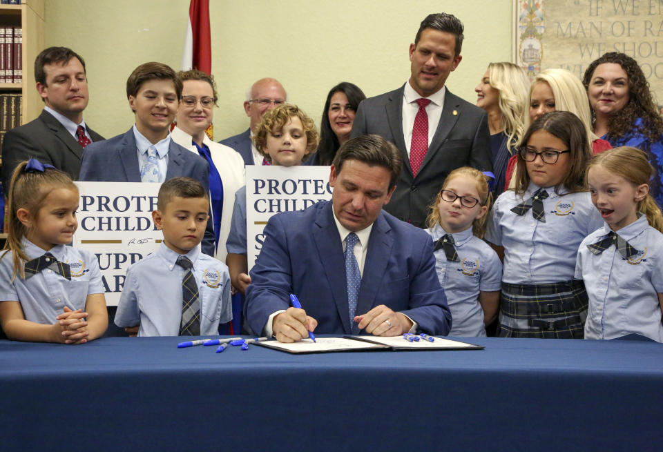 FILE - Florida Gov. Ron DeSantis signs the Parental Rights in Education bill, also known as the "Don't say gay" bill, at Classical Preparatory School, on March 28, 2022, in Shady Hills, Fla. DeSantis has emerged as a rival of former President Donald Trump and likely has his eyes set on the White House for the 2024 election. (Douglas R. Clifford/Tampa Bay Times via AP, File)