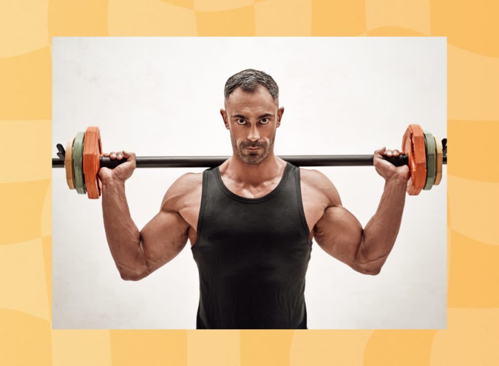 fit middle-aged man holding barbell