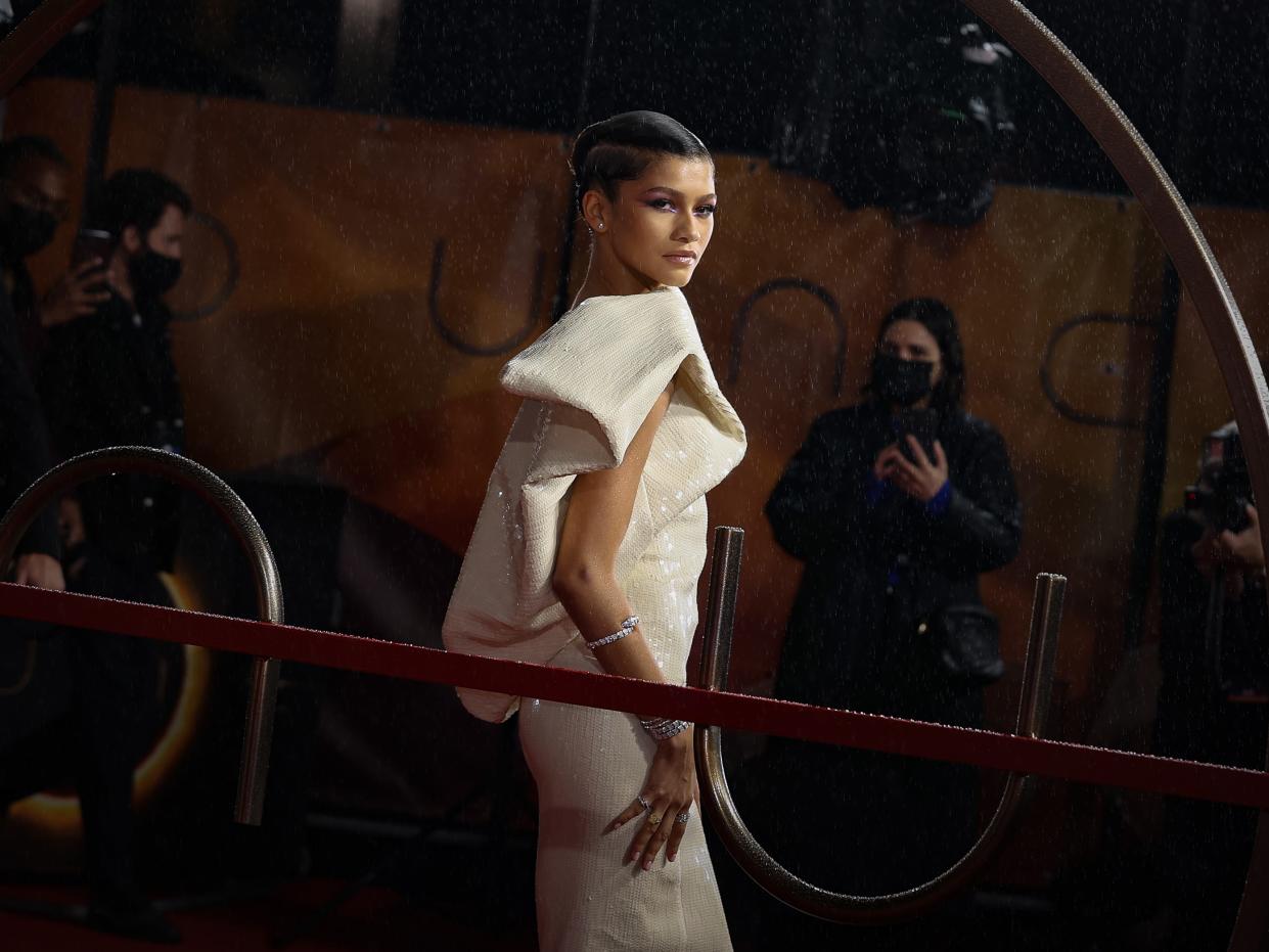 Zendaya posing in a white dress at a UK screening of her film "Dune."