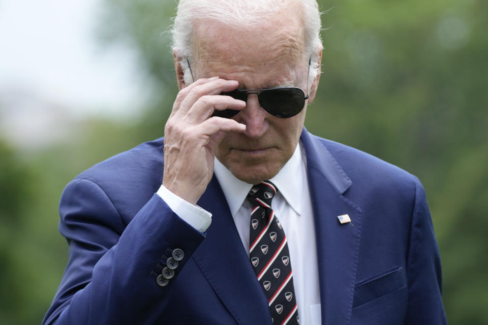 President Joe Biden removes his sunglasses as he walks to speak with reporters after returning to the White House in Washington, Sunday, May 28, 2023. Biden and House Speaker Kevin McCarthy came to an "agreement in principle" on the debt limit Saturday that would avert a potentially disastrous U.S. default, but still has to pass both houses of Congress. (AP Photo/Manuel Balce Ceneta)