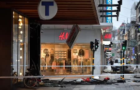 STOCKHOLM 2017-04-08 People laying flowers near the crime scene in central Stockholm the morning after a hijacked beer truck plowed into pedestrians on Drottninggatan and crashed into Ahlens department store on Friday, killing four people, injuring 15 others. TT News Agency/Jonas Ekstromer/via REUTERS
