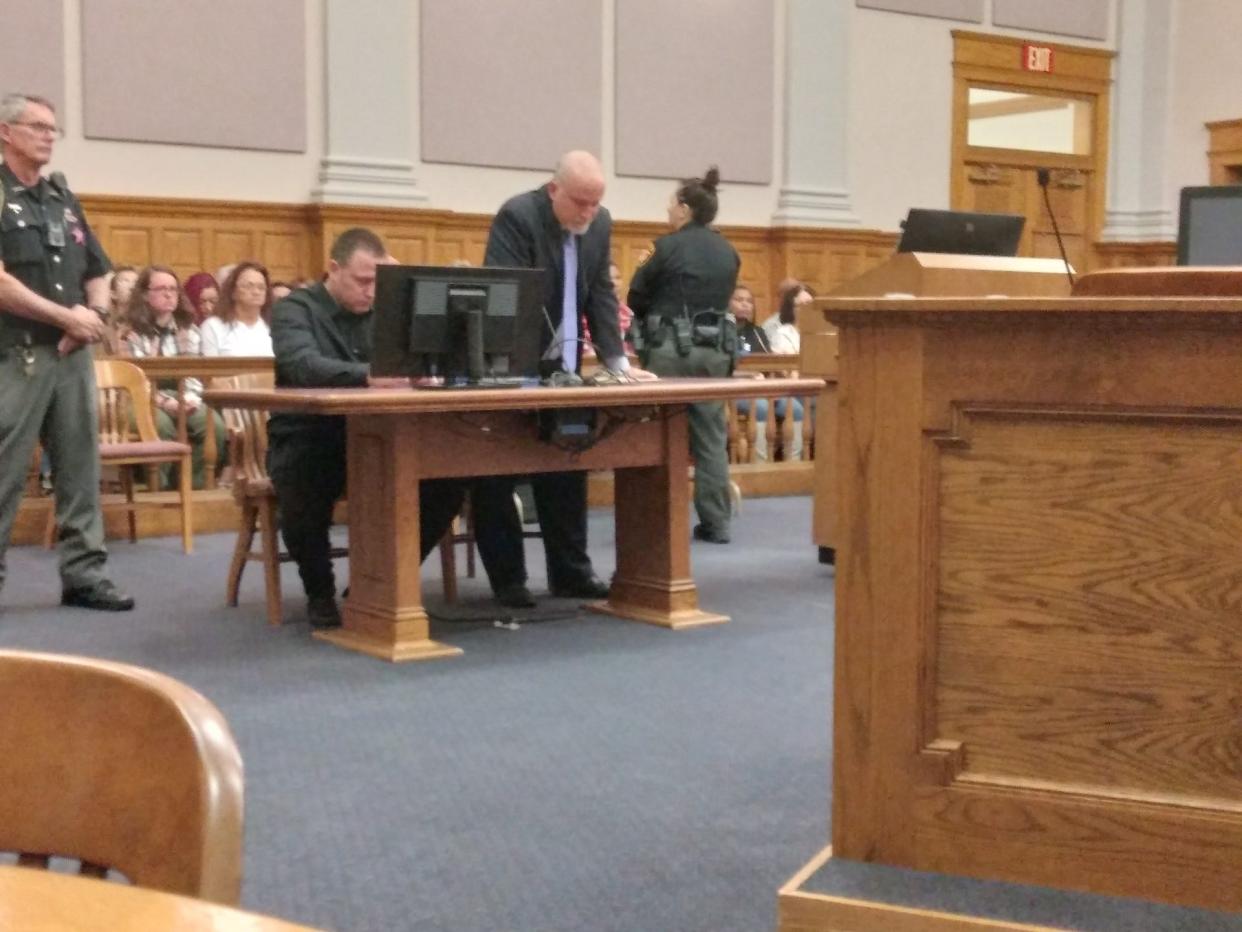 Shaun M. Cunningham sits at the defense table in Stark County Common Pleas Court on Friday, with his attorney Rick Pitinii, standing. On Friday, a jury convicted Cunningham of murder for killing Travis L. Charles in 2022.