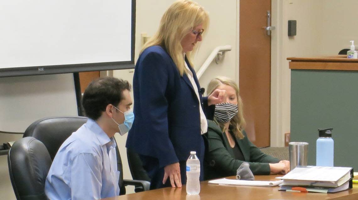 Timothy Banowetz, left, listens to Public Defender Mary Copeland announce on Oct. 5, 2021, that he has agreed to plead guilty to the murder of Edwardsville attorney Randy Gori. Assistant Public Defender Delani Hemmer sits at right in a courtroom at the Madison County Criminal Justice Center.