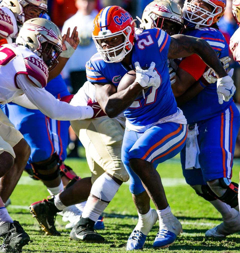 Florida Gators running back Dameon Pierce (27) drives to the end zone in the second half to make it 24-7 Florida.The Florida Gators defeated the Florida State Seminoles 24-21 Saturday November 27, 2021 at Ben Hill Griffin Stadium in Gainesville, Florida.