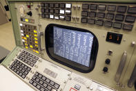 A screen displays simulated telemetry data on the the console for the Booster Systems Engineer, the first position on the first row known as "The Trench", inside the Apollo mission control room as it is restored to replicate the Apollo mission era for the 50th anniversary of the Apollo moon landing at the NASA Johnson Space Center Monday, June 17, 2019, in Houston. (AP Photo/Michael Wyke)