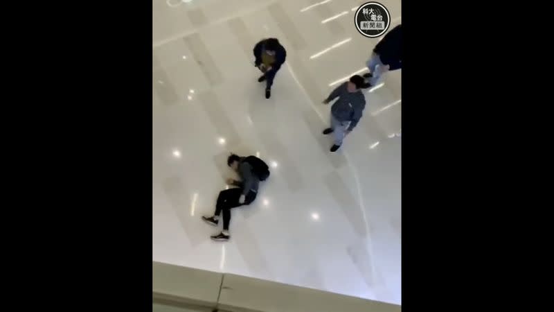 A man lies on the floor after he jumped from the second storey in Yuen Long mall as he tried to evade police in Hong Kong