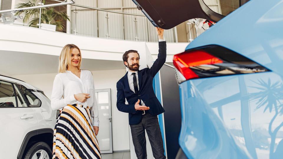 woman looking at new car