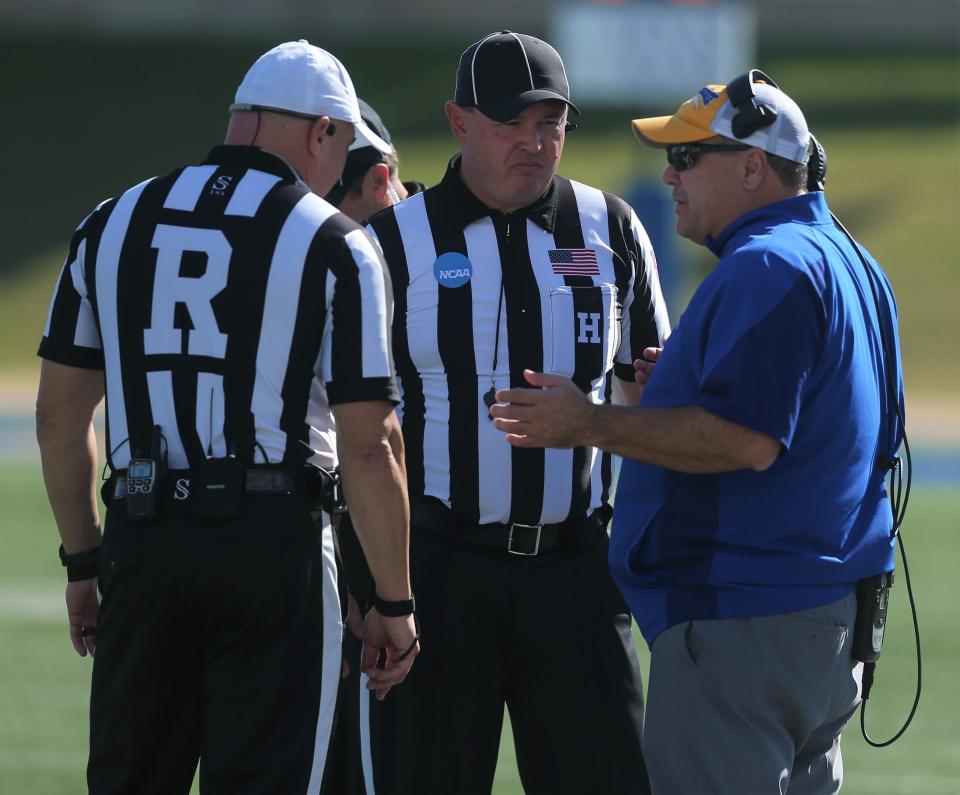 Angelo State University head football coach Jeff Girsch talks to the officiating crew during an NCAA Division II first-round playoff game against Minnesota-Duluth at LeGrand Stadium at 1st Community Credit Union Field on Saturday, Nov. 20, 2021.