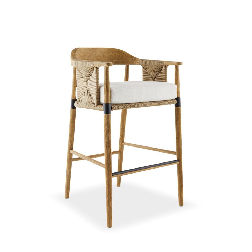 high wood stool with white seat cushion and some rattan sides