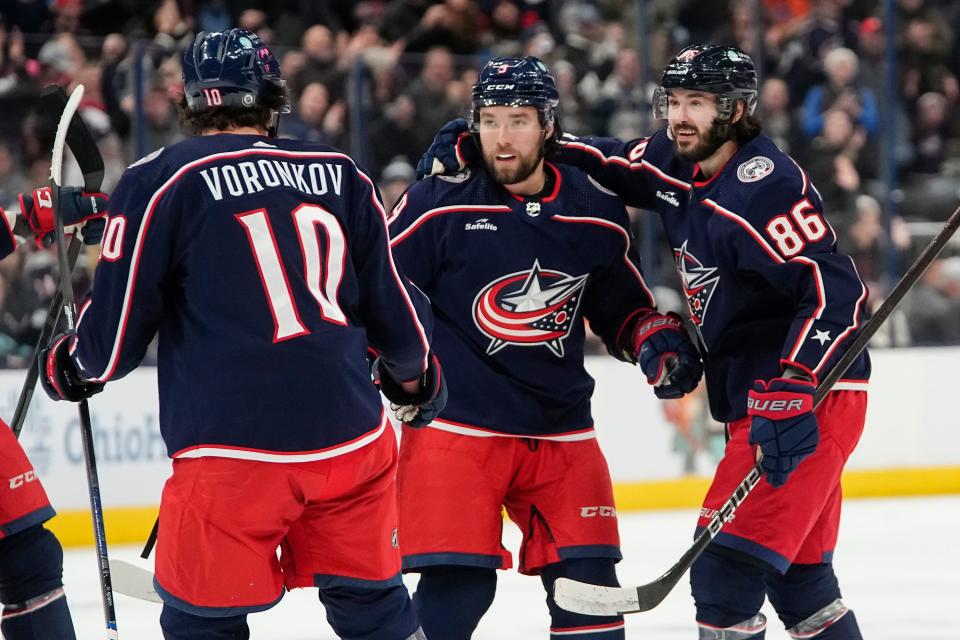 Jan 13, 2024; Columbus, Ohio, USA; Columbus Blue Jackets left wing Dmitri Voronkov (10) and right wing Kirill Marchenko (86) celebrate a goal by defenseman Ivan Provorov (9), his second of the period, during the first period of the NHL hockey game against the Seattle Kraken at Nationwide Arena.