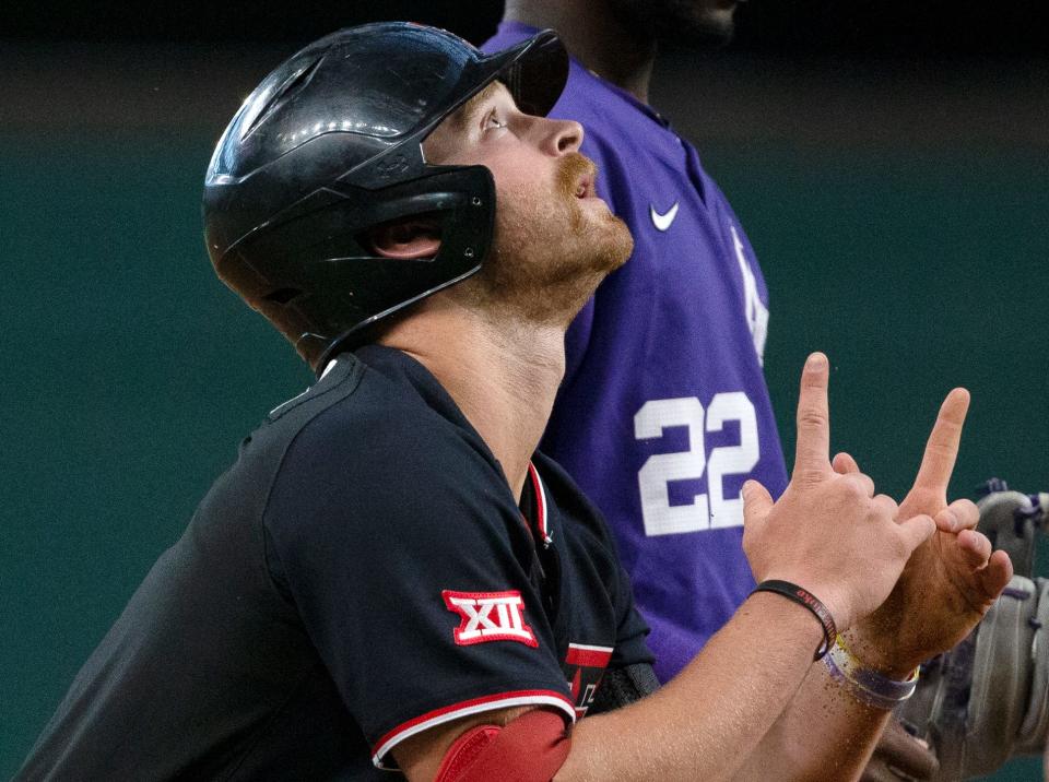 Texas Tech center fielder Dillon Carter gestures skyward after he hit a two-run triple in the Red Raiders' 5-3 victory Wednesday against Kansas State. The game was both teams' opener in the Big 12 tournament at Globe Life Field in Arlington.