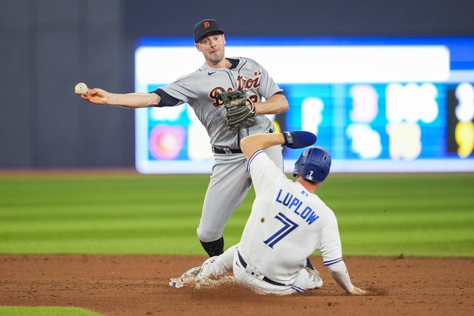 Tigers shortstop Ryan Kreidler turns a double play over Blue Jays pinch runner Jordan Luplow in the eighth inning of the Tigers' 3-1 win over the Blue Jays on Thursday, April, 13, 2023, in Toronto.