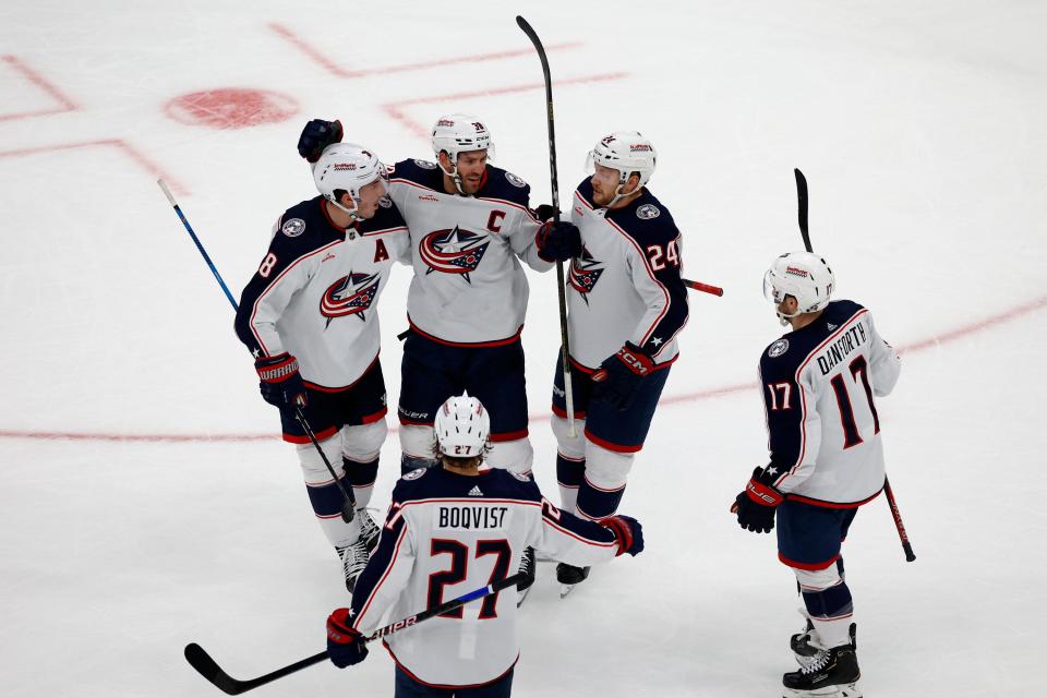 Columbus Blue Jackets center Boone Jenner, center, is congratulated by teammates Zach Werenski, Mathieu Olivier, Adam Boqvist, and Justin Danforth after scoring a goal against the Boston Bruins during the second period of an NHL hockey game, Sunday, Dec. 3, 2023, in Boston. (AP Photo/Mary Schwalm)