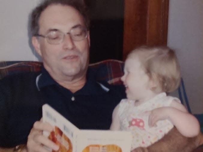 Grandpa and toddler reading book