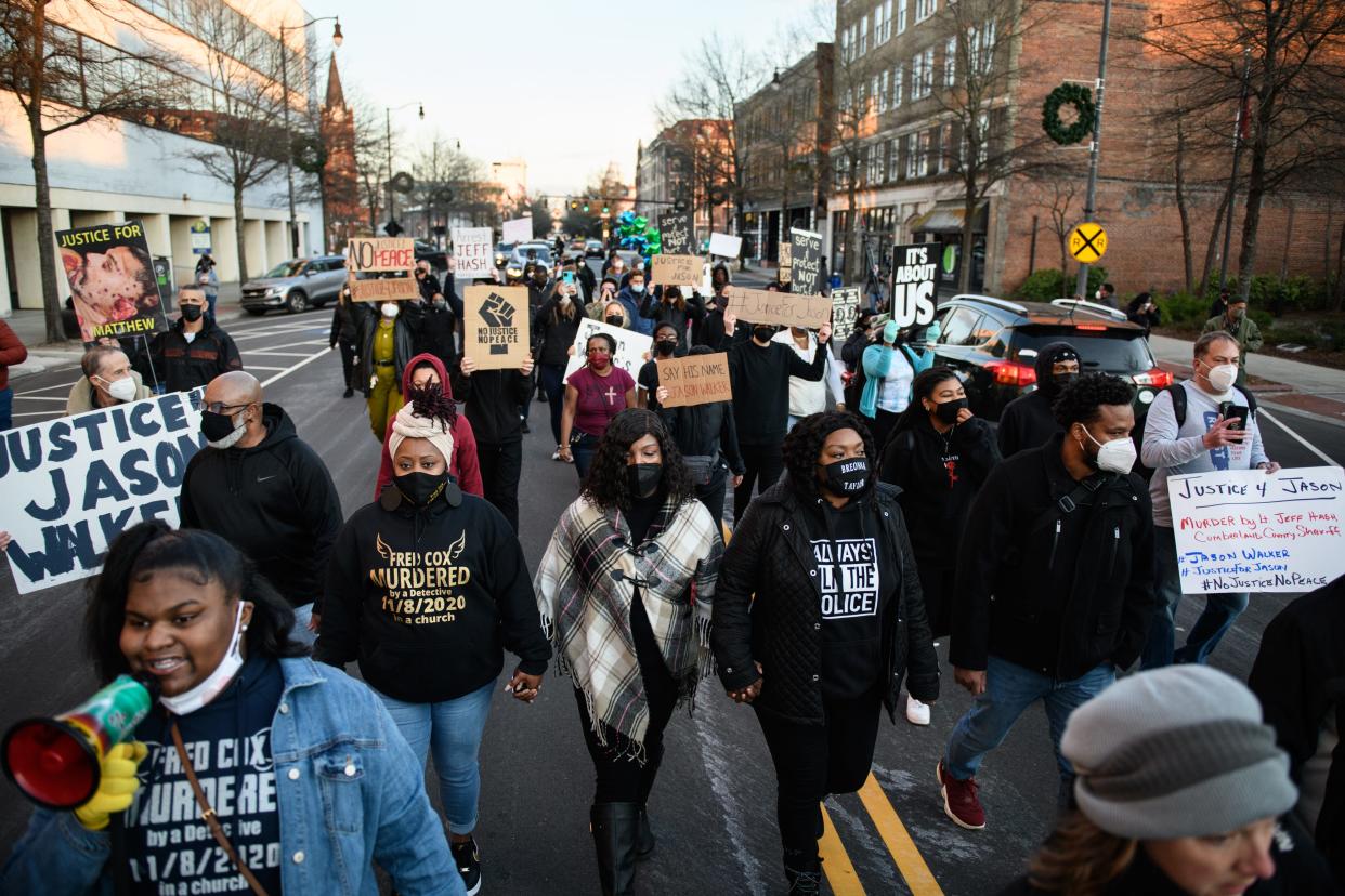 Demonstrators march through downtown Fayetteville during a Justice for Jason Walker demonstration on Friday, Jan. 14, 2022. Jason Walker, 37, was shot and killed on Saturday by an off-duty Cumberland County Sheriff’s deputy.