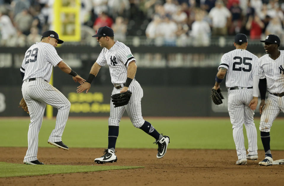 From left, New York Yankees' Gio Urshela, DJ LeMahieu, Gleyber Torres and Didi Gregorius celebrate after defeating the Boston Red Sox in a baseball game, Saturday, June 29, 2019, in London. Major League Baseball made its European debut game Saturday at London Stadium. (AP Photo/Tim Ireland)