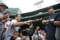New York Yankees' Derek Jeter chats with fans as he signs autographs prior to the Yankees' baseball game against the Boston Red Sox at Fenway Park in Boston, Tuesday, April 22, 2014. (AP Photo/Elise Amendola)