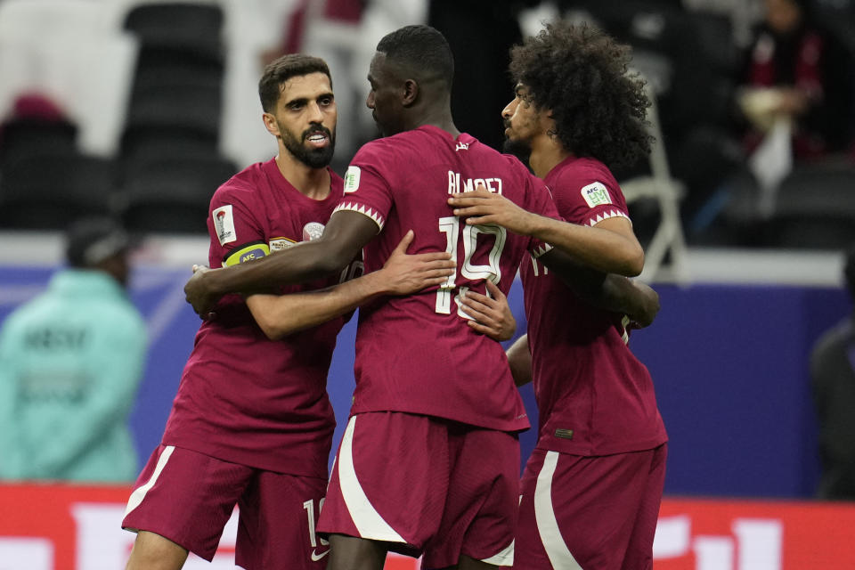 Qatar's Hasan Al Haydos, left, Almoez Ali, center, and Akram Afif celebrate after the Asian Cup Group A soccer match between Tajikistan and Qatar at Al Bayt stadium, in Al Khor, Qatar, Wednesday, Jan. 17, 2024. Qatar won 1-0. (AP Photo/Aijaz Rahi)