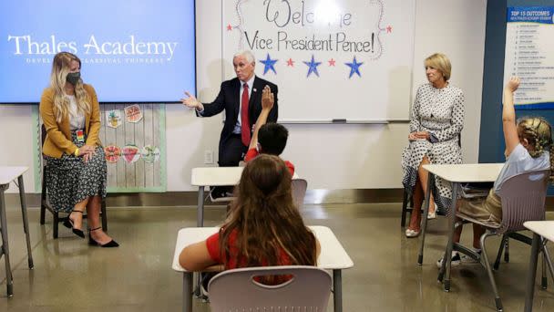 PHOTO: Vice President Mike Pence and Education Secretary Betsy DeVos visit with teacher Allison Combs, left, and her fourth grade students at Thales Academy which reopened to students in Apex, N.C., July 29, 2020. (Gerry Broome/AP)