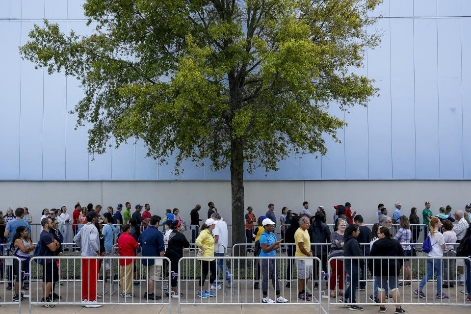 People line up to volunteer at NRG Center, which opened its doors to evacuees in the wake of Tropical Storm Harvey, on Wednesday in Houston. (AP) 