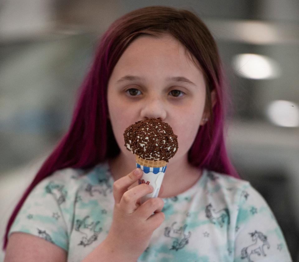 Emmalina Duncan, 9, of Holliston, enjoys an ice cream cone with sprinkles during a recent visit to Bertie's Creative Creamery in Milford, April 17, 2024.