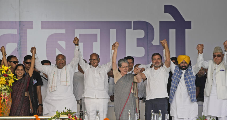 Opposition leaders from various parties raise their hands during the 'Save Democracy' rally organized by INDIA bloc, a group formed by opposition parties, in New Delhi, India, Sunday, March 31, 2024. The “Save Democracy” rally was the first major public demonstration by the opposition bloc INDIA against the arrest of New Delhi’s top elected official and opposition leader Arvind Kejriwal on March 21, in a liquor bribery case. (AP Photo/Manish Swarup)