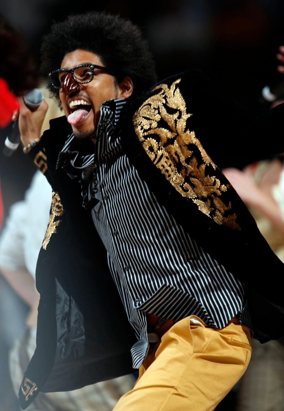 Greg "Shock G" Jacobs, leader for the Digital Underground, performs The Humpty Dance during a halftime appearance at an NBA game in 2008.