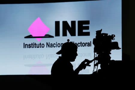 A cameraman works inside the National Electoral Institute (INE) headquarters ahead of the upcoming July 1 presidential election, in Mexico City, Mexico, June 30, 2018. REUTERS/Daniel Becerril