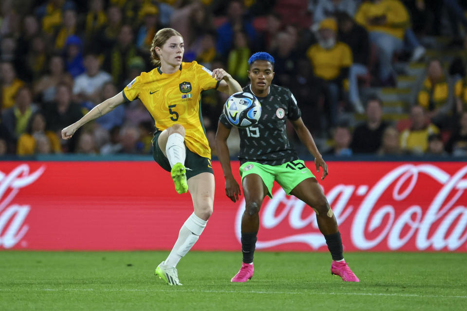 Australia's Cortnee Vine, left, shoots the ball next to Nigeria's Rasheedat Ajibade during the Women's World Cup Group B soccer match between Australia and Nigeria In Brisbane, Australia, Thursday, July 27, 2023. (AP Photo/Tertius Pickard)