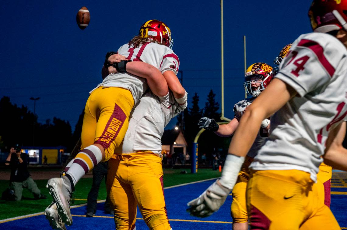 Enumclaw’s Emmit Otero is lifted up by offensive lineman Ryan Fehr after scoring a touchdown in the second quarter of 2A SPSL game against Fife on Thursday, Sept. 22, 2022, at Fife High School in Fife, Wash.